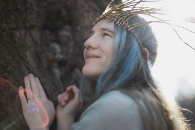 Close up pagan styled woman with sunshine halo around hair portrait picture