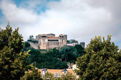 Buildings and trees against sky