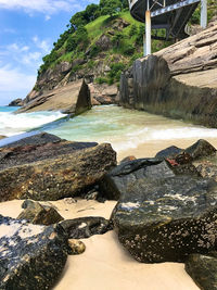 Rocks on beach against sky