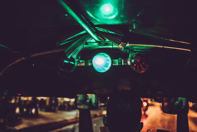 Close-up of man photographing illuminated smart phone at night
