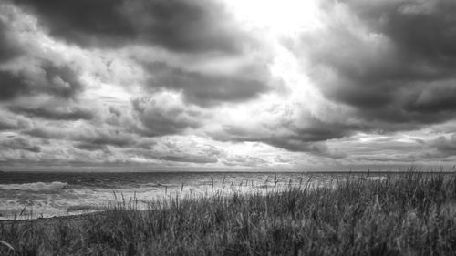 Scenic view of sea against storm clouds