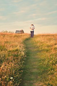 Man standing on field against sky