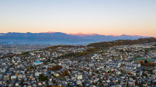 High angle shot of townscape against sky during sunset