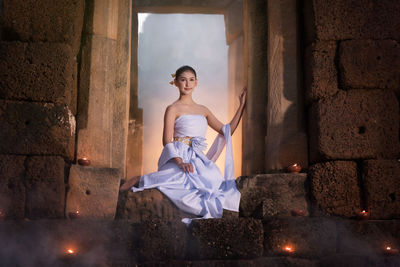 Woman standing against wall