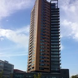 Low angle view of building against cloudy sky