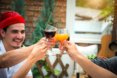 Young man drinking beer in glass