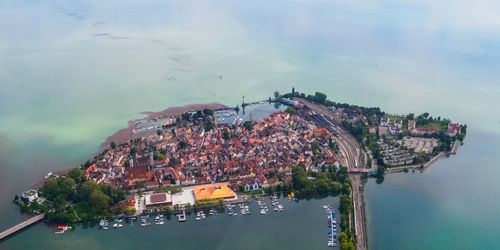 High angle view of city by sea against sky