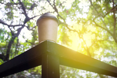 Low angle view of metal pole against trees in forest