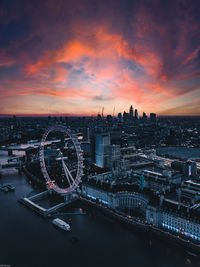 Aerial view of buildings against cloudy sky during sunset