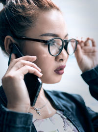 Young female asian talking on the phone