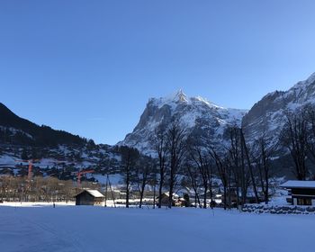 Scenic view of snowcapped mountains against clear blue sky