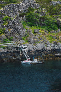 Sailboat on rock by sea