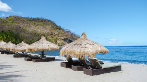 Scenic view of beach against clear blue sky