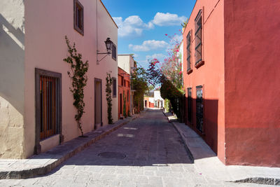 Empty alley amidst buildings in city