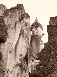 Low angle view of statue against temple