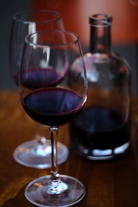 A couple sharing a bottle of red wine in winter. 