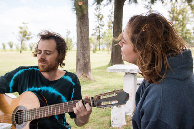 Sweet couple playing guitar and singing