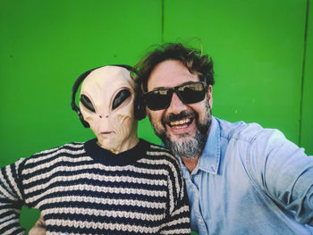 Portrait of smiling man with alien