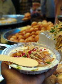 Close-up of hand holding salad