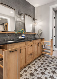 Bathroom in luxury home with double vanity and ornate tile floor