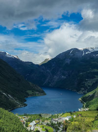 Scenic view of sea and mountains against sky