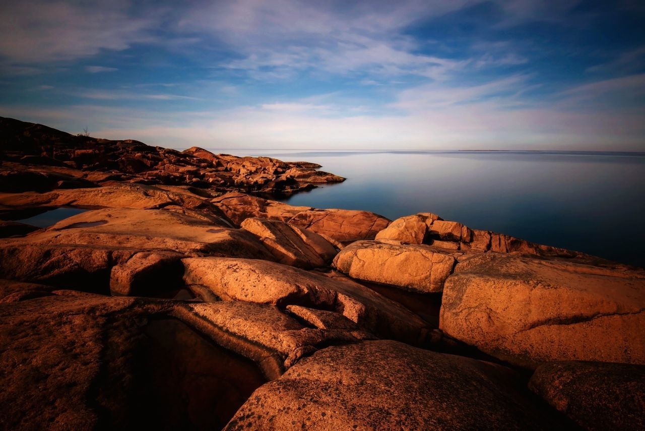 tranquility, sky, tranquil scene, scenics, rock - object, water, beauty in nature, nature, sea, cloud - sky, rock formation, rock, cloud, idyllic, remote, outdoors, non-urban scene, horizon over water, calm, no people