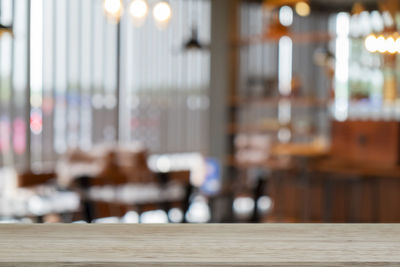 Defocused image of illuminated lights on table in restaurant