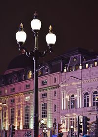 Low angle view of illuminated street light at night