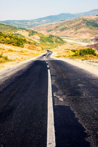 Road amidst landscape against sky