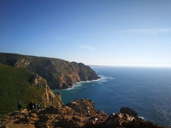 Scenic view of cliff and sea against sky