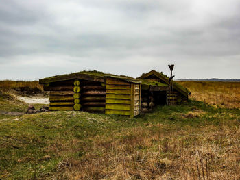 Abandoned building on field against sky