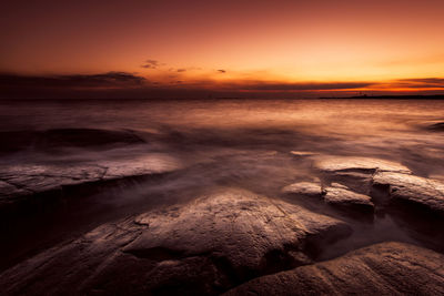 Scenic view of sea at sunset