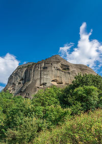 View of rocky mountain against blue sky