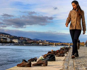 Woman walking by shoes at danube river