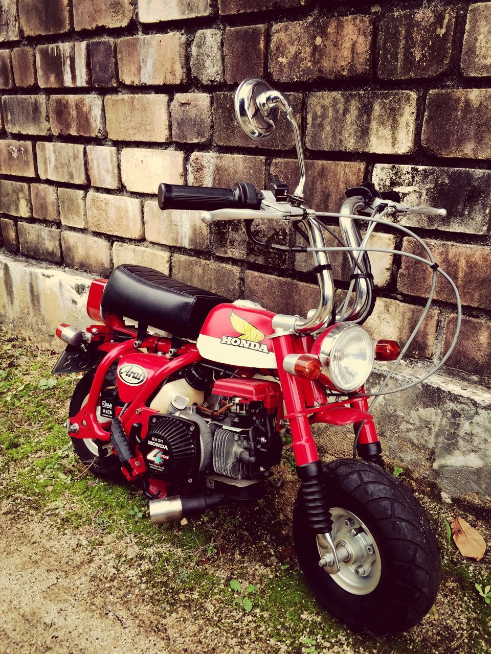 land vehicle, transportation, mode of transport, bicycle, childhood, stationary, street, day, red, high angle view, motorcycle, outdoors, protection, parking, safety, parked, metal, wall - building feature, security