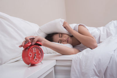 Portrait of woman sleeping on bed at home