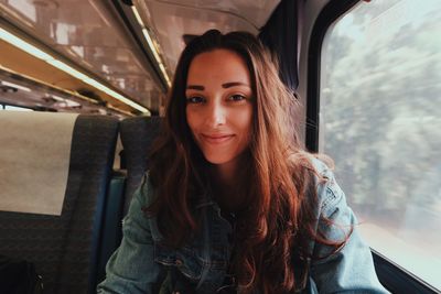 Portrait of young woman sitting in car