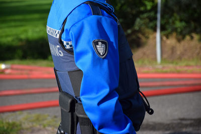 Rear view of man standing on road