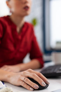 Midsection of businesswoman using computer