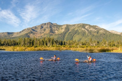 A man and woman kayaking on lake tahoe, ca