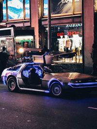 Cars on illuminated street at night