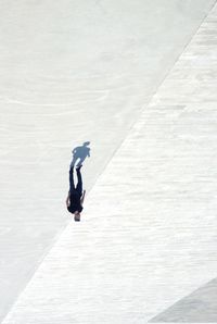 Upside down image of man walking on footpath