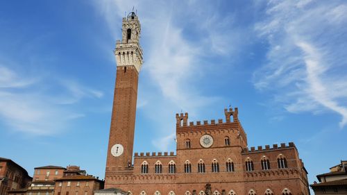 Low angle view of clock tower against sky