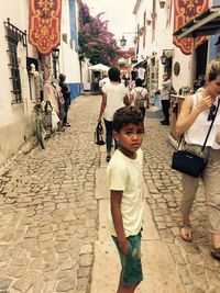 Boy standing on street in obidos 