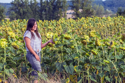 Girl smiling while standing at sunflower farm