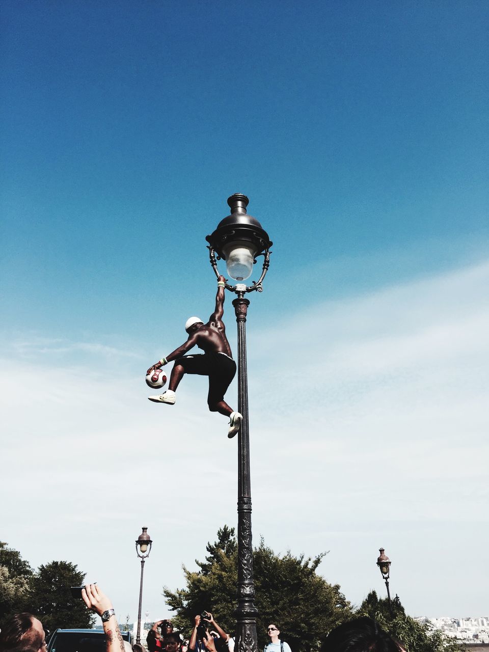 street light, low angle view, sky, lighting equipment, blue, tree, pole, clear sky, transportation, day, lamp post, outdoors, cloud, cloud - sky, bicycle, no people, nature, copy space, mode of transport, sunlight