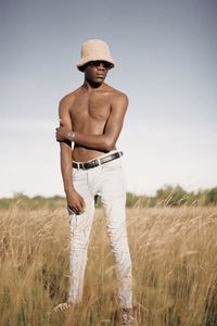 Young black man standing in the field in zimbabwe 