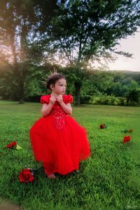 Woman with red flowers on field