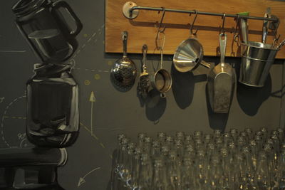 Close-up of glass bottles against kitchen utensils