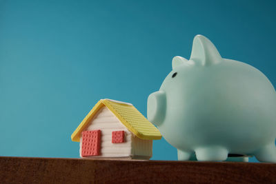 Close-up of piggy bank against blue background